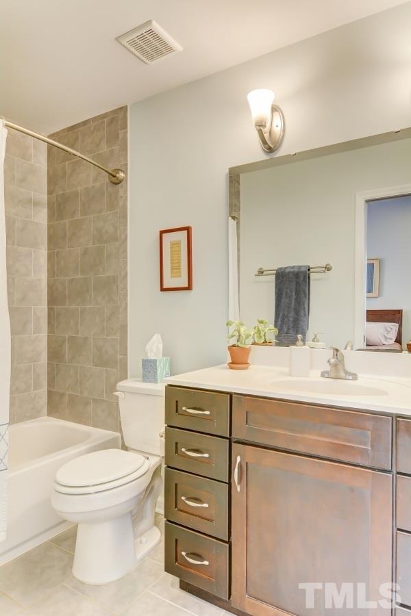 1719 Bennett Street Raleigh, NC 27604 - Photo 11 of 18 a bathroom with a sink a toilet and shower