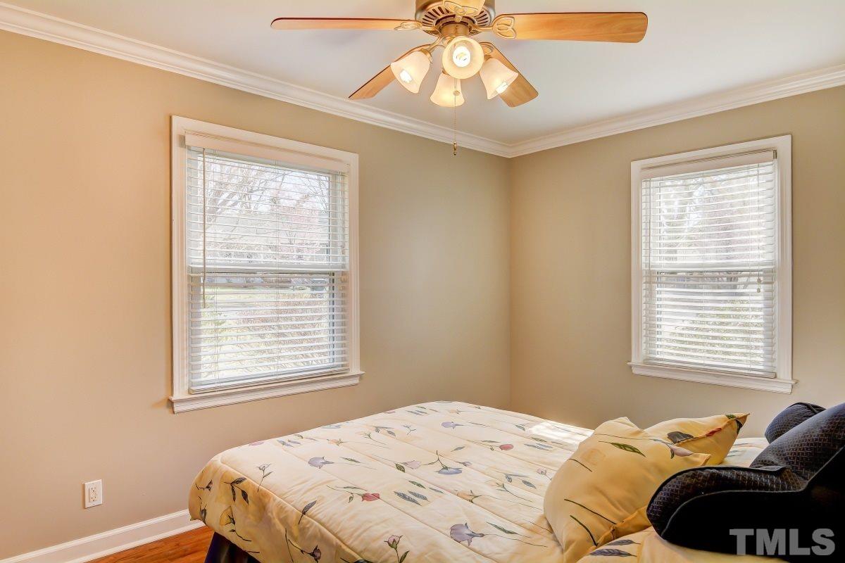 1719 Bennett Street Raleigh, NC 27604 - Photo 13 of 18 a bedroom with a bed window and a chandelier