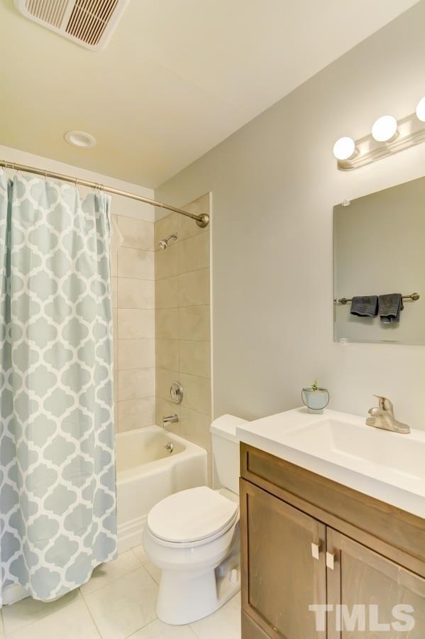 1719 Bennett Street Raleigh, NC 27604 - Photo 14 of 18 a bathroom with a sink toilet and shower