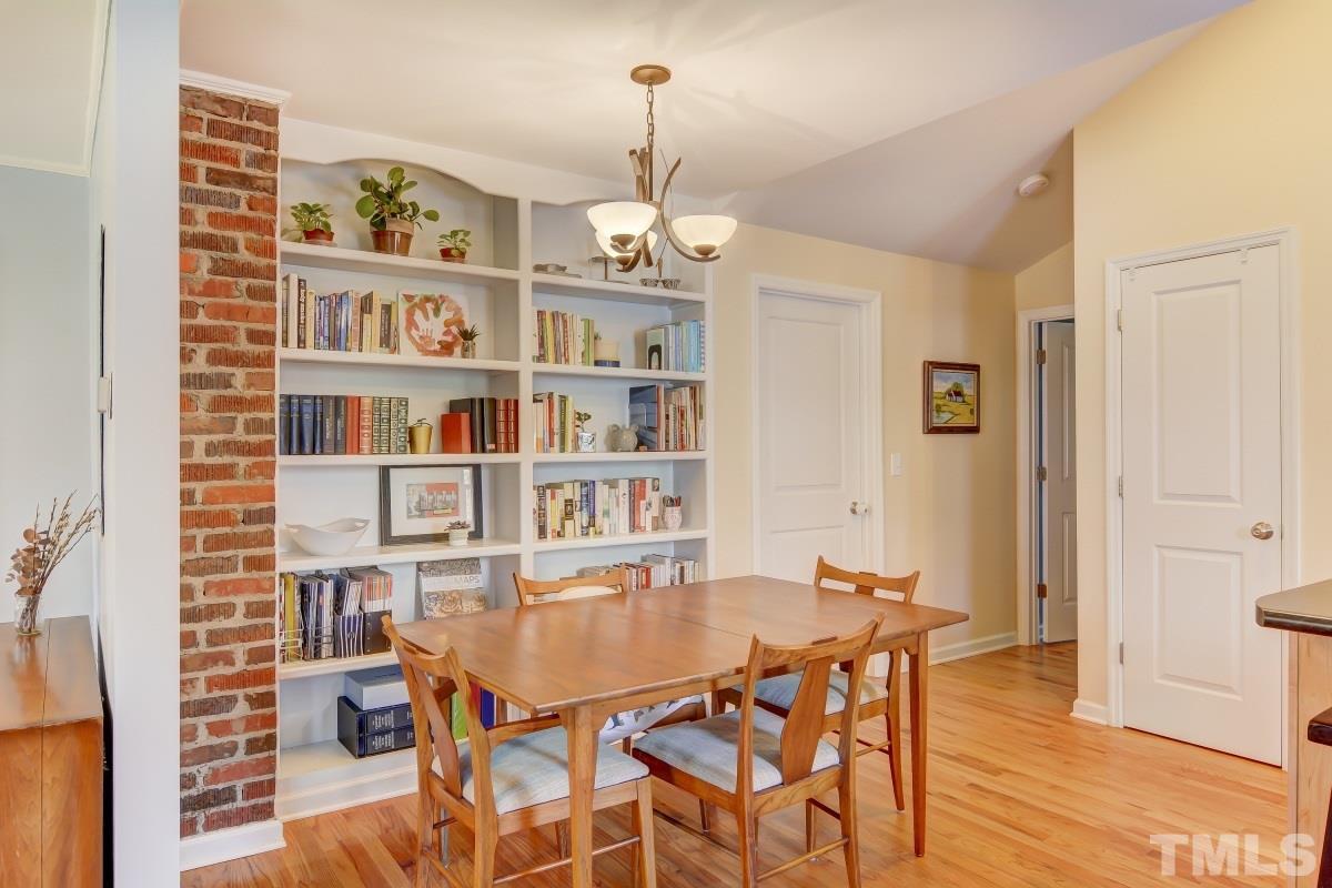 1719 Bennett Street Raleigh, NC 27604 - Photo 5 of 18 a dining room with furniture a book and wooden floor