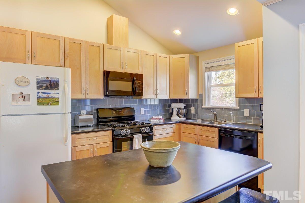 1719 Bennett Street Raleigh, NC 27604 - Photo 6 of 18 a kitchen with a sink a stove and cabinets