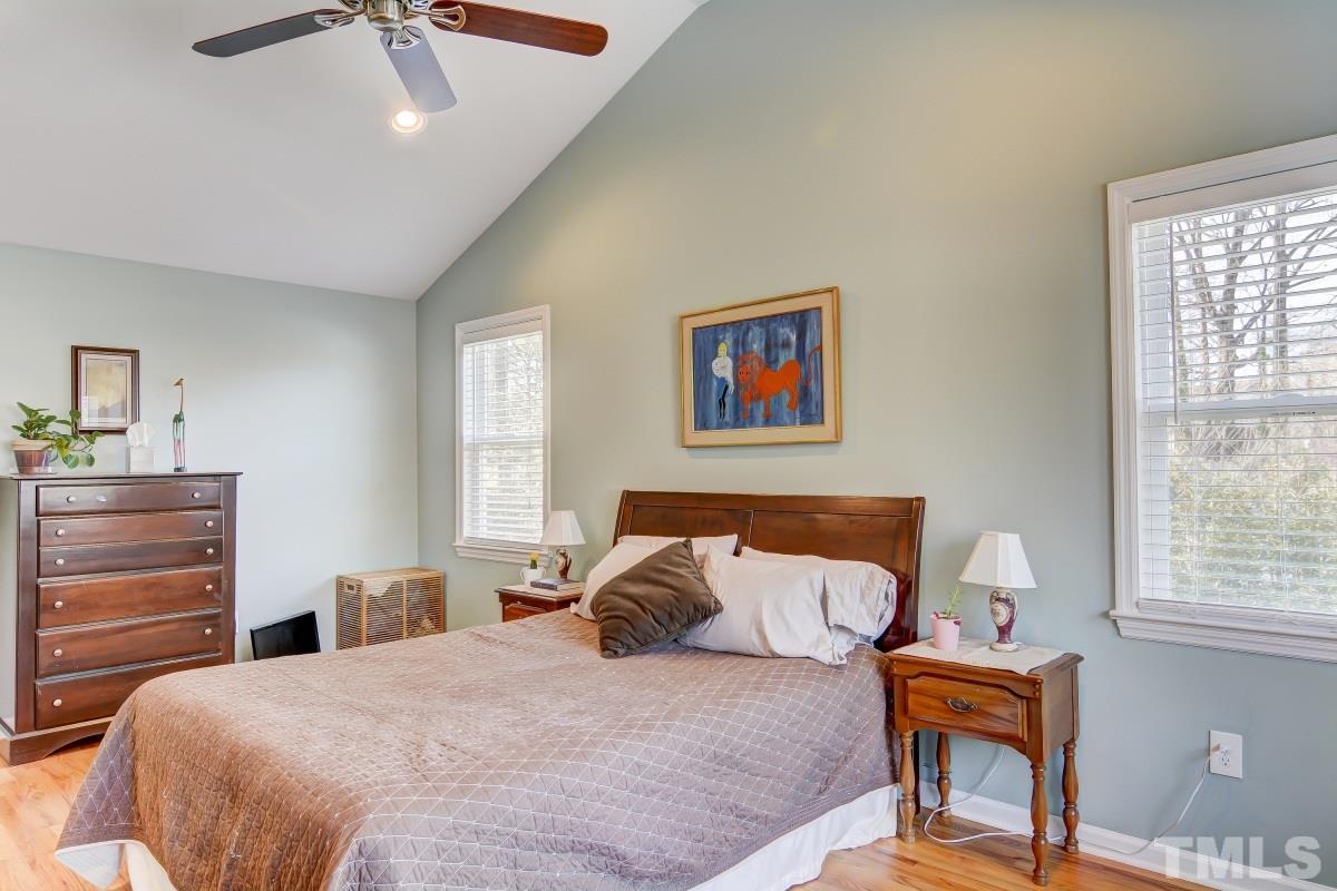 1719 Bennett Street Raleigh, NC 27604 - Photo 10 of 18 a bedroom with a bed and wooden floor