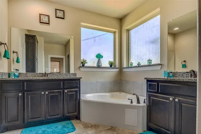 a bath room with a sink and a mirror