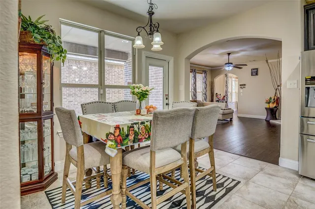 a view of a dining room with furniture wooden floor and a chandelier