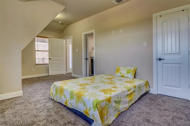 a bedroom with a bed and window