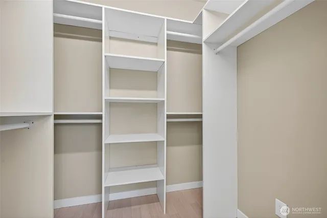 a view of walk in closet with empty racks