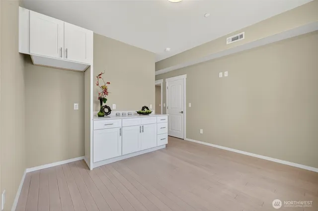 a bathroom with a toilet a sink a mirror a vanity and shower