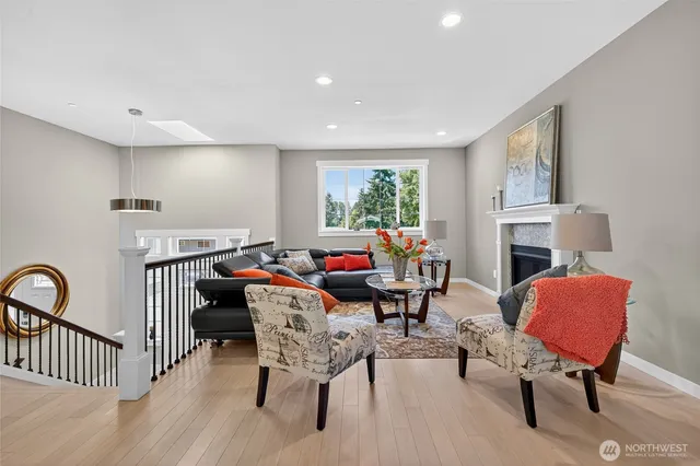 a living room with furniture two window and a fireplace