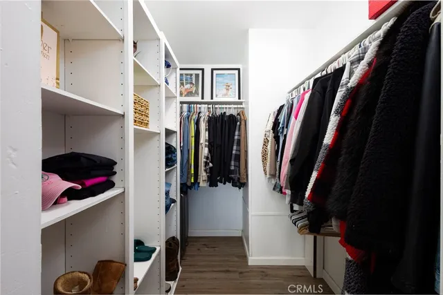 a bedroom with a bed and a flat tv screen on wall