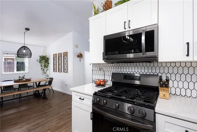 a kitchen with stainless steel appliances a sink and cabinets