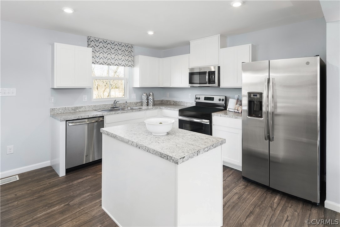 1140 Canterbury Ridge Road Richmond, VA 23224 - Photo 6 of 13 a kitchen with stainless steel appliances granite countertop a refrigerator a sink a stove a microwave and wooden floor