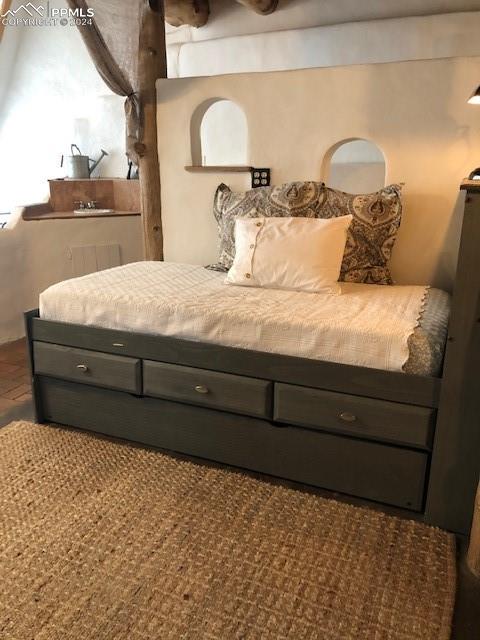 654 Tess Trace Road Guffey, CO 80820 - Photo 15 of 42 a bedroom with a bed and window