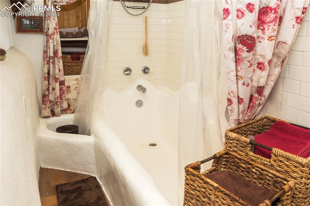 654 Tess Trace Road Guffey, CO 80820 - Photo 24 of 42 a bathroom with a bathtub and shower