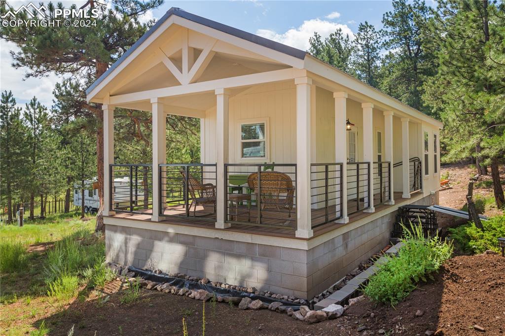 654 Tess Trace Road Guffey, CO 80820 - Photo 27 of 42 a front view of a house with a garden