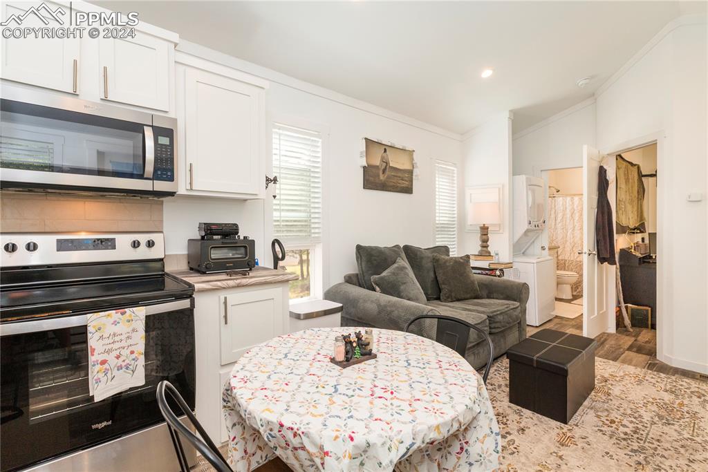 654 Tess Trace Road Guffey, CO 80820 - Photo 29 of 42 a living room with stainless steel appliances furniture a rug and a fireplace