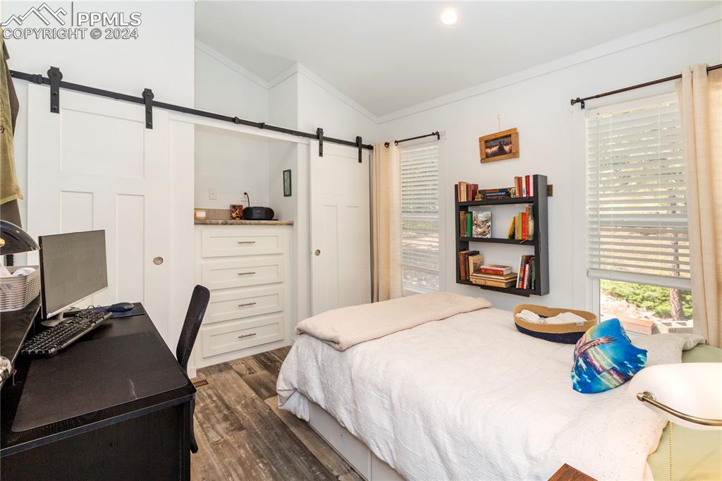 654 Tess Trace Road Guffey, CO 80820 - Photo 30 of 42 a bedroom with a bed and a book shelf