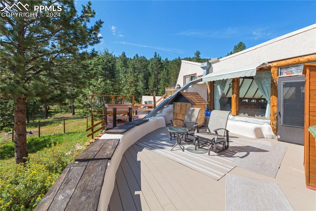 654 Tess Trace Road Guffey, CO 80820 - Photo 3 of 42 a view of a patio with couches table and chairs and potted plants