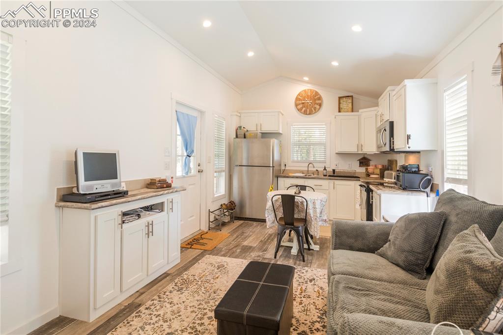 654 Tess Trace Road Guffey, CO 80820 - Photo 31 of 42 a living room with stainless steel appliances furniture and a kitchen view
