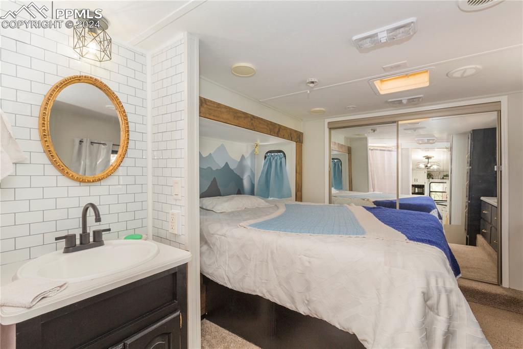 654 Tess Trace Road Guffey, CO 80820 - Photo 35 of 42 a spacious bathroom with a sink a mirror and a shower