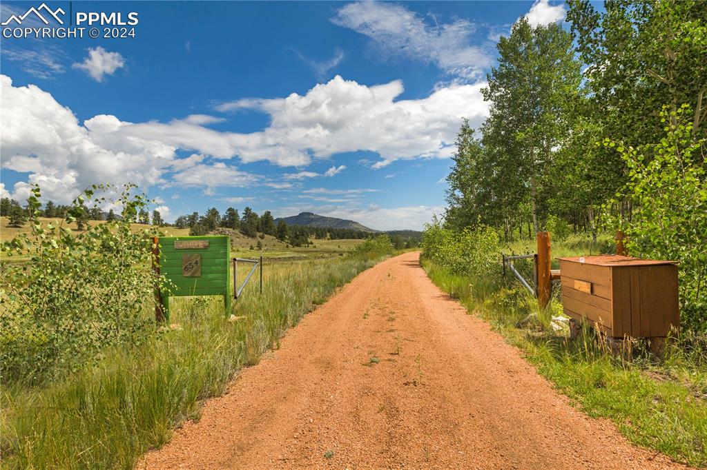 654 Tess Trace Road Guffey, CO 80820 - Photo 36 of 42 a view of a lake with a house in the background