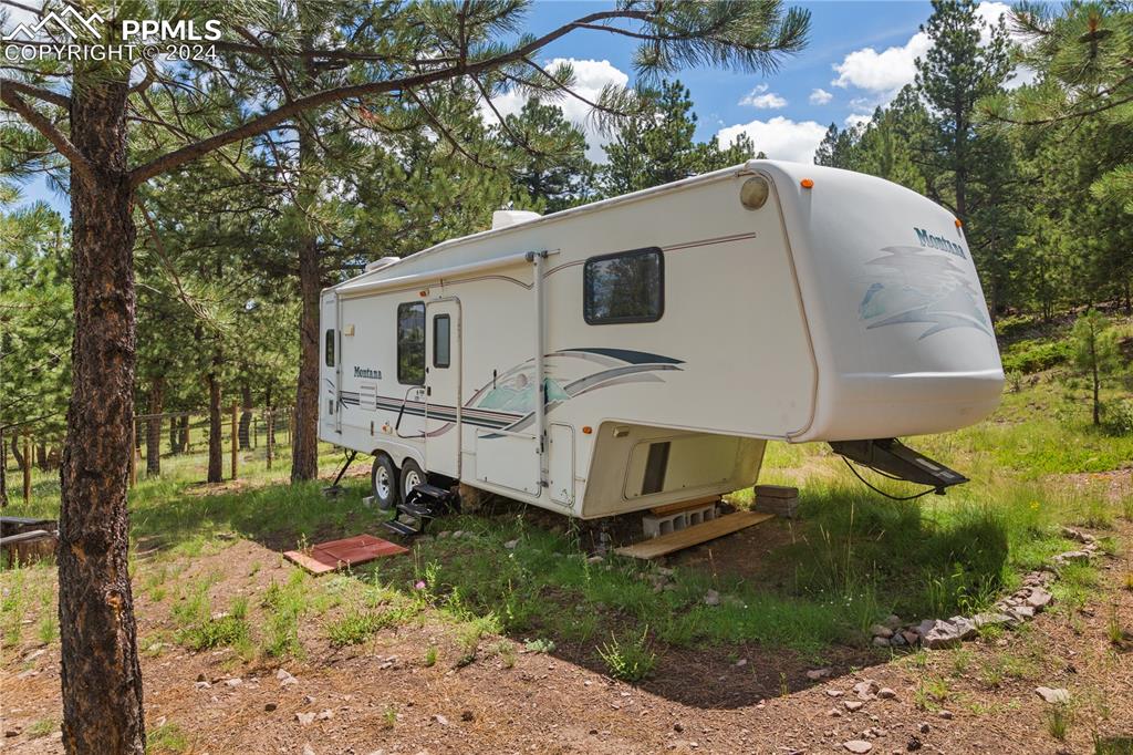 654 Tess Trace Road Guffey, CO 80820 - Photo 42 of 42 a view of a small house in a yard with large trees