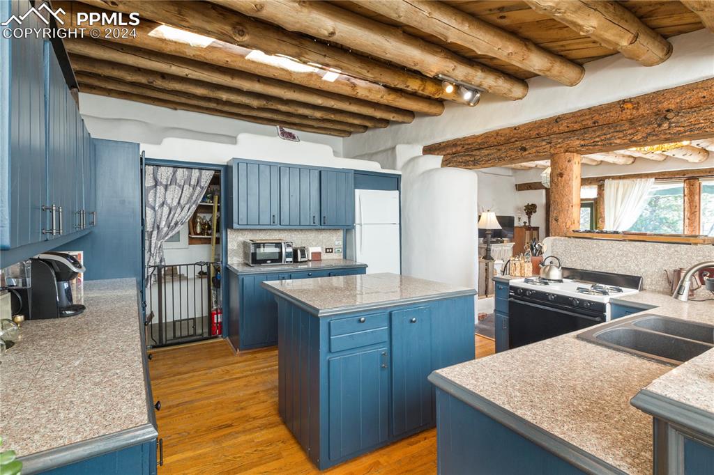 654 Tess Trace Road Guffey, CO 80820 - Photo 5 of 42 a kitchen with a stove a refrigerator and a sink