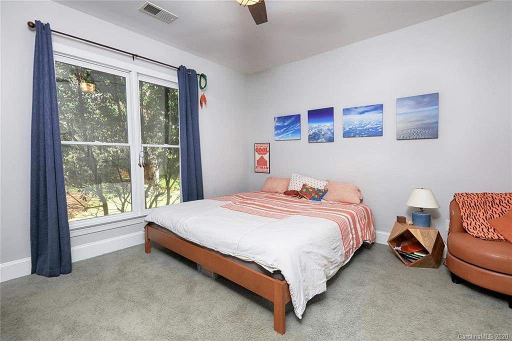 148 Morrison Hill Road Davidson, NC 28036 - Photo 22 of 33 a bedroom with a bed and a couch