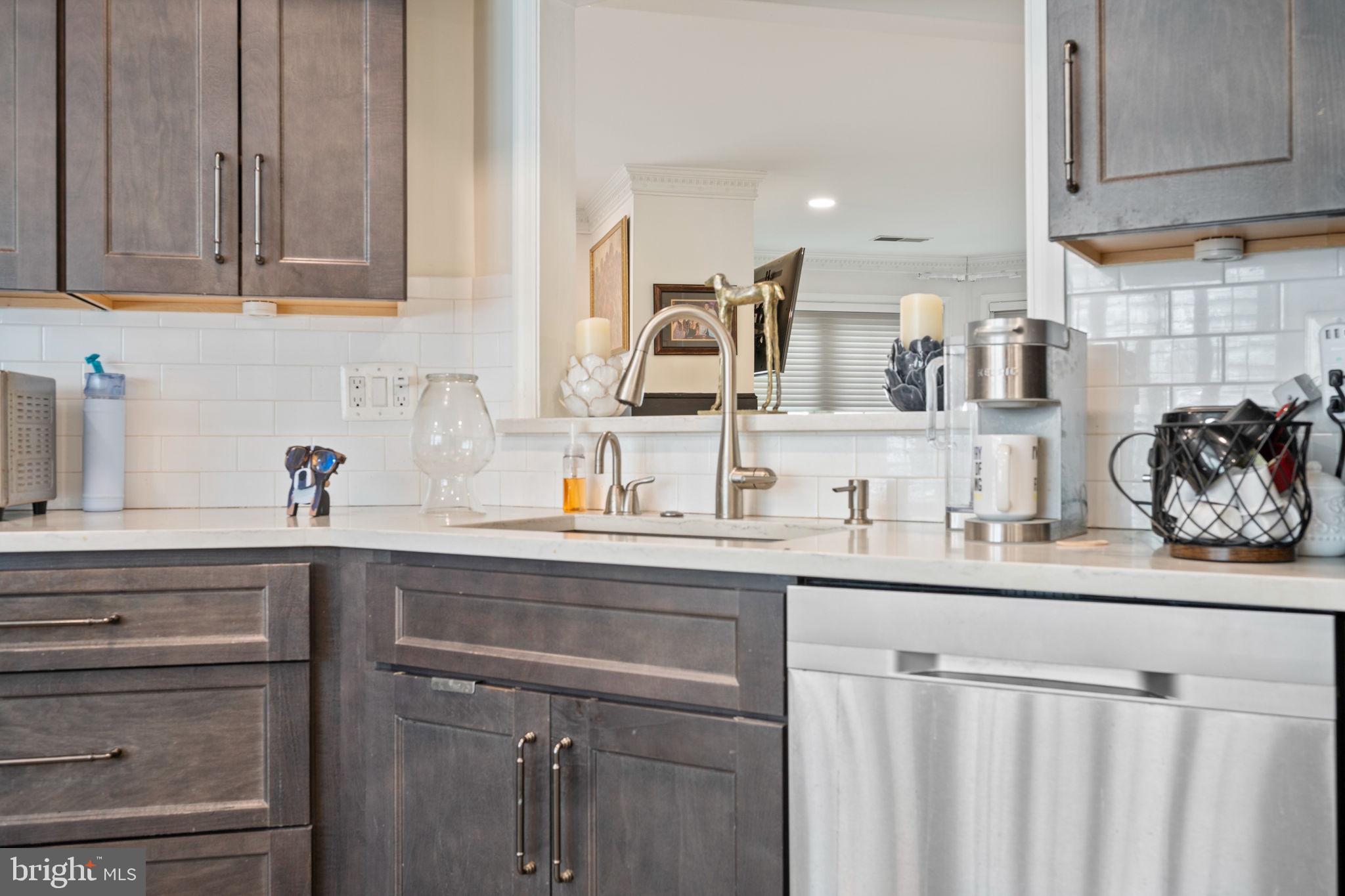 9136 Ruth Elder Lane, Unit 9136 Pikesville, MD 21208 - Photo 4 of 11 a kitchen with stainless steel appliances granite countertop a sink and cabinets