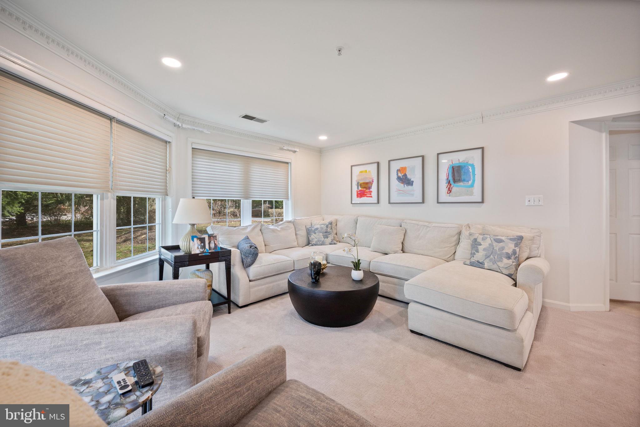 9136 Ruth Elder Lane, Unit 9136 Pikesville, MD 21208 - Photo 5 of 11 a living room with furniture a large window and a couch