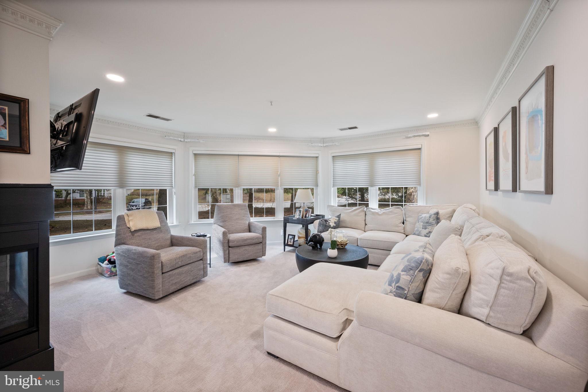 9136 Ruth Elder Lane, Unit 9136 Pikesville, MD 21208 - Photo 6 of 11 a living room with furniture and a flat screen tv