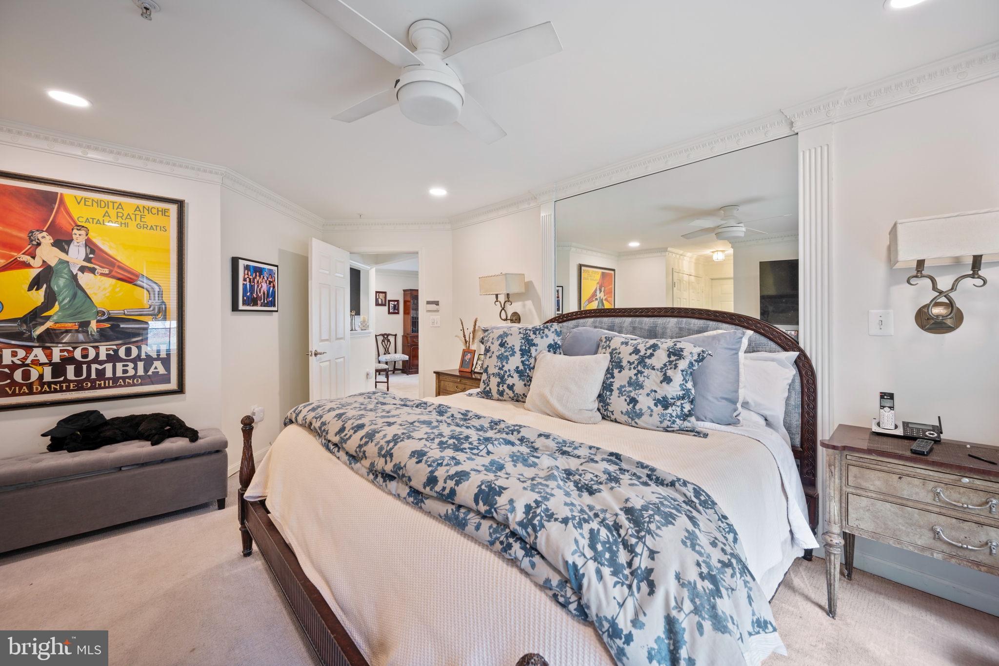 9136 Ruth Elder Lane, Unit 9136 Pikesville, MD 21208 - Photo 7 of 11 a bedroom with a bed and a chandelier