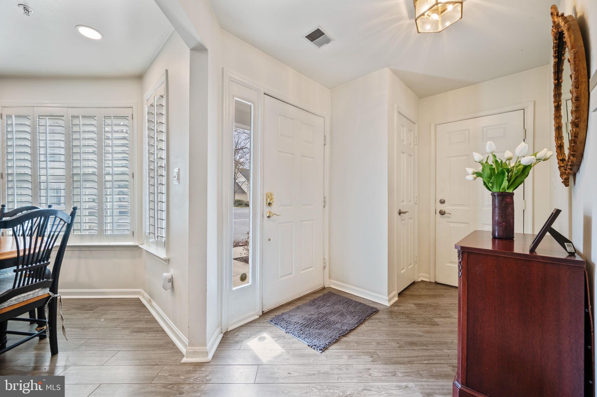 9136 Ruth Elder Lane, Unit 9136 Pikesville, MD 21208 - Photo 10 of 11 a view of a livingroom with wooden floor and a potted plant