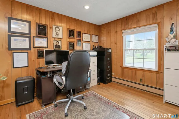 a view of workspace with wooden floor windows