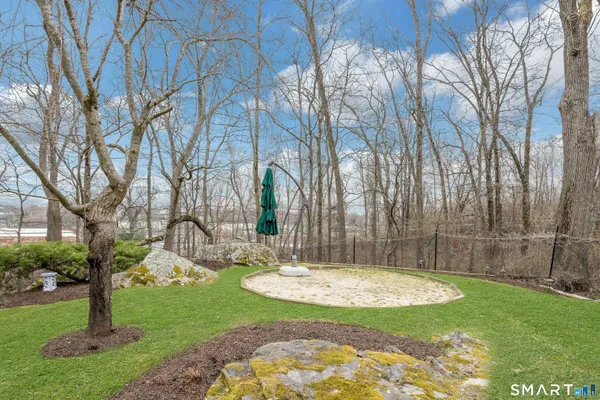 a view of a backyard with large trees