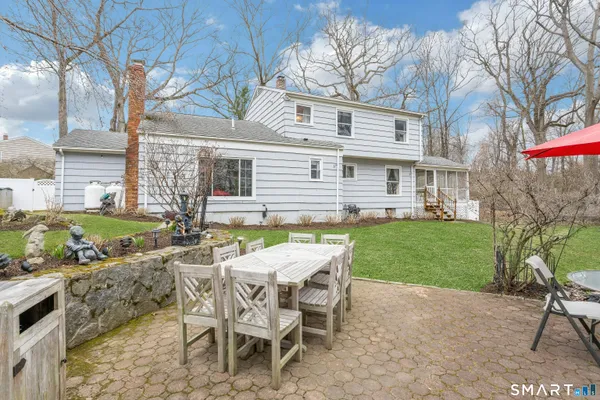a view of a house with a yard and sitting area