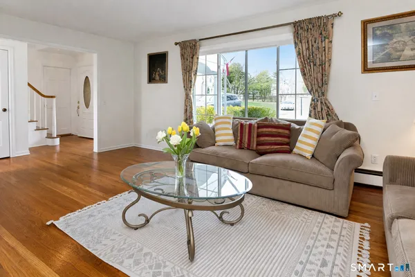 a living room with furniture and a wooden floor