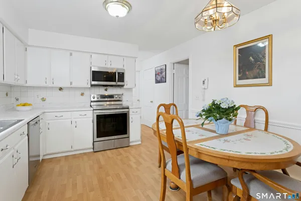 a view of a dining room with furniture and a kitchen