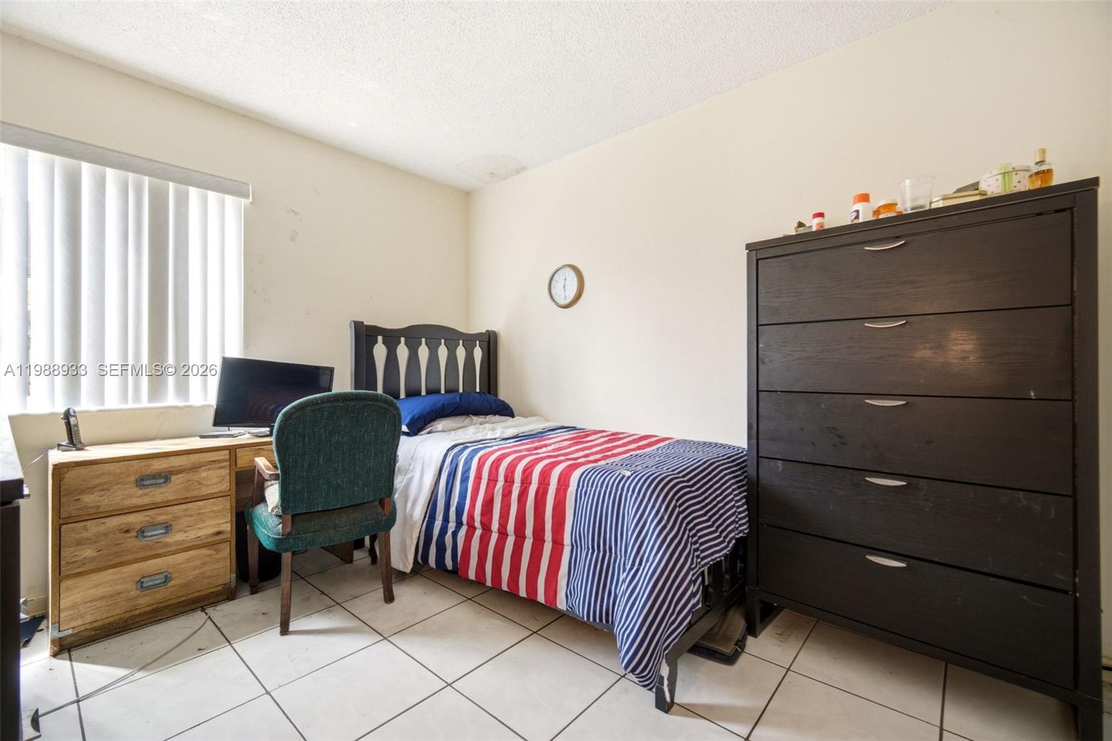 841 Southwest 55th Avenue Margate, FL 33068 - Photo 26 of 26 a bedroom with a bed and a dresser