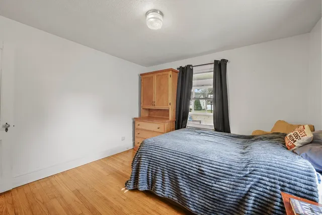 a bedroom with a bed and window
