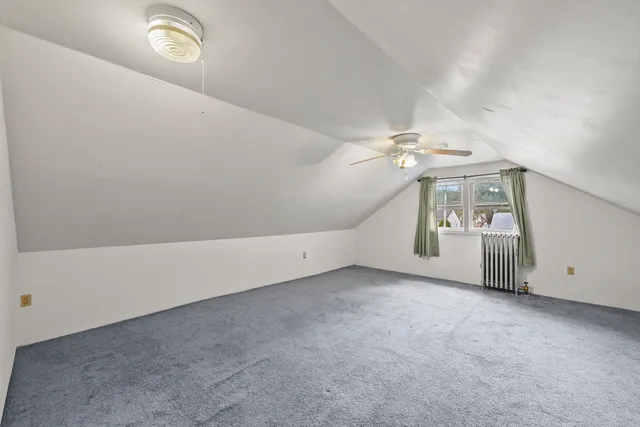 en empty room with windows and ceiling fan