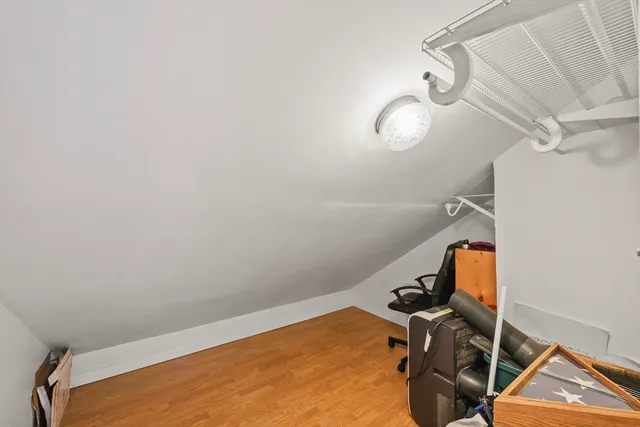 a room with gym equipment and view of a mirror