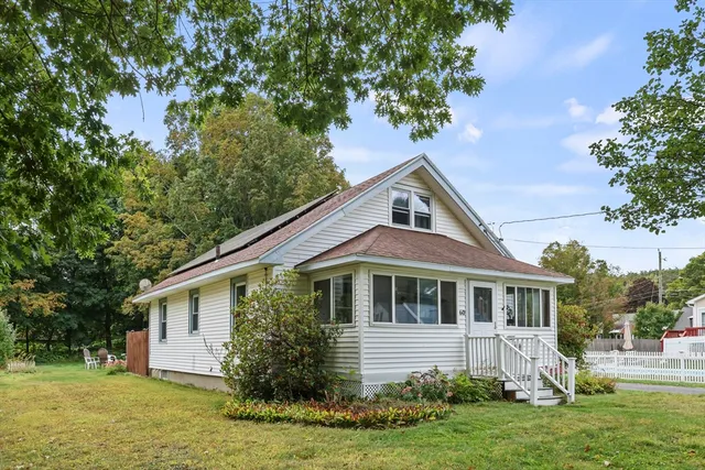 a front view of house with yard and green space