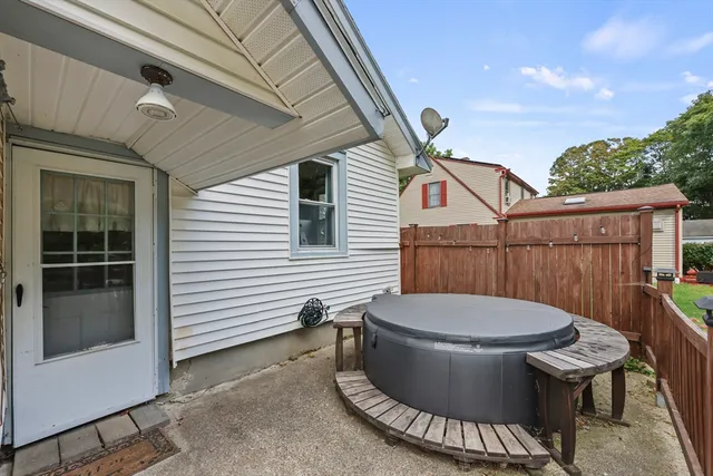 a view of a patio with table and chairs and wooden floor