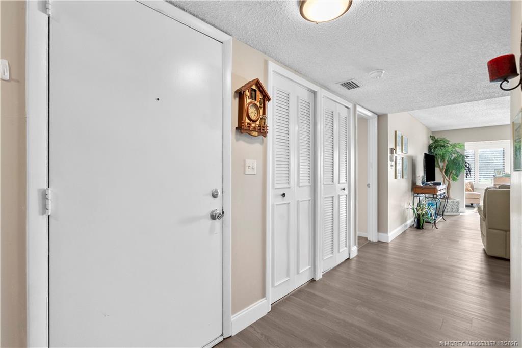 5313 Southeast Miles Grant Road, Unit K209 Stuart, FL 34997 - Photo 11 of 34 a view of an entryway with wooden floor