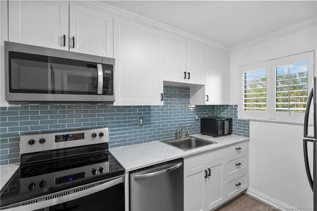 a kitchen that has a sink and a stove