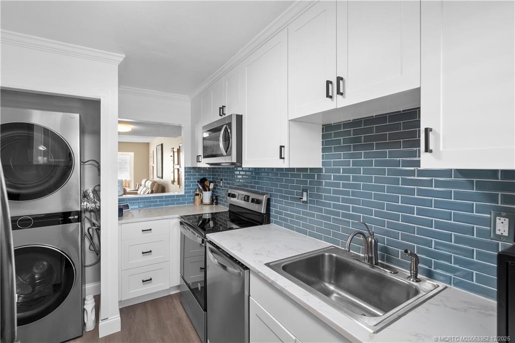 5313 Southeast Miles Grant Road, Unit K209 Stuart, FL 34997 - Photo 13 of 34 a kitchen that has a sink and a stove