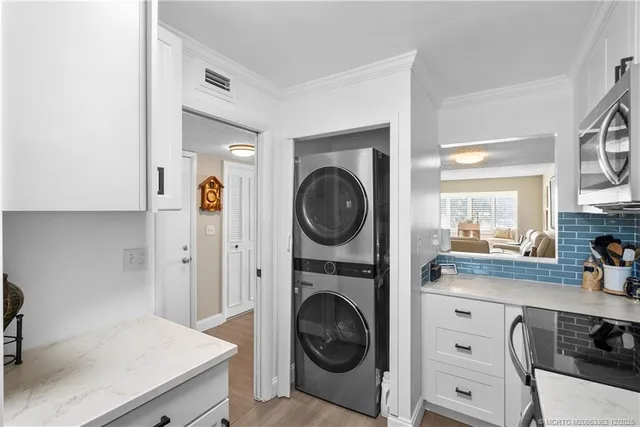 a kitchen with granite countertop a stove and a microwave