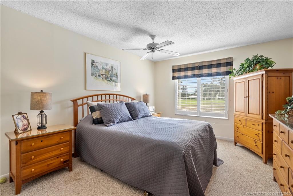 5313 Southeast Miles Grant Road, Unit K209 Stuart, FL 34997 - Photo 16 of 34 a bedroom with a bed and a dresser