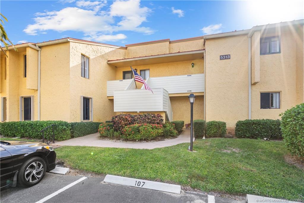 5313 Southeast Miles Grant Road, Unit K209 Stuart, FL 34997 - Photo 20 of 34 a car parked in front of a house