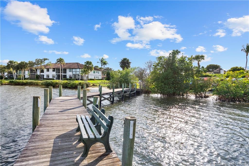 5313 Southeast Miles Grant Road, Unit K209 Stuart, FL 34997 - Photo 24 of 34 a view of a patio with chairs and a table